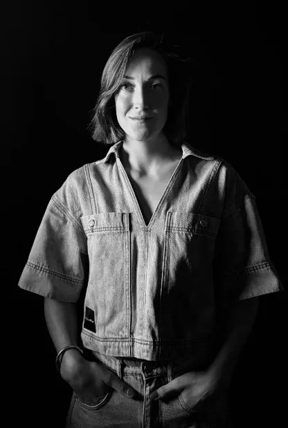 DJ RICHÈL - black and white picture of her standig and facing the camera.